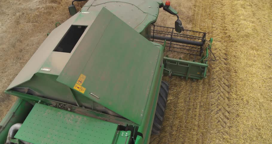 Combine harvester working outdoors on a field at a farm during day time