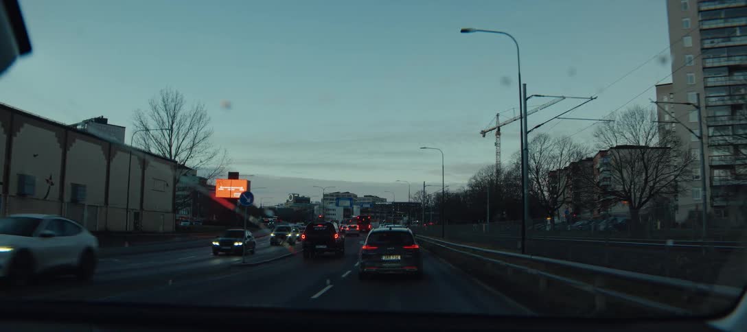 A view of some cars driving around in a city