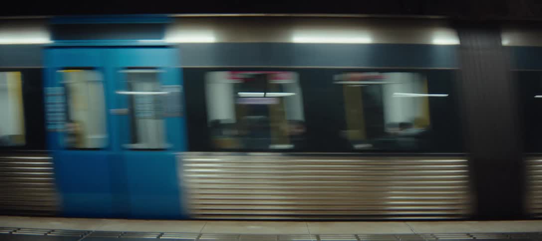 Train in motion passing through an underground station platform