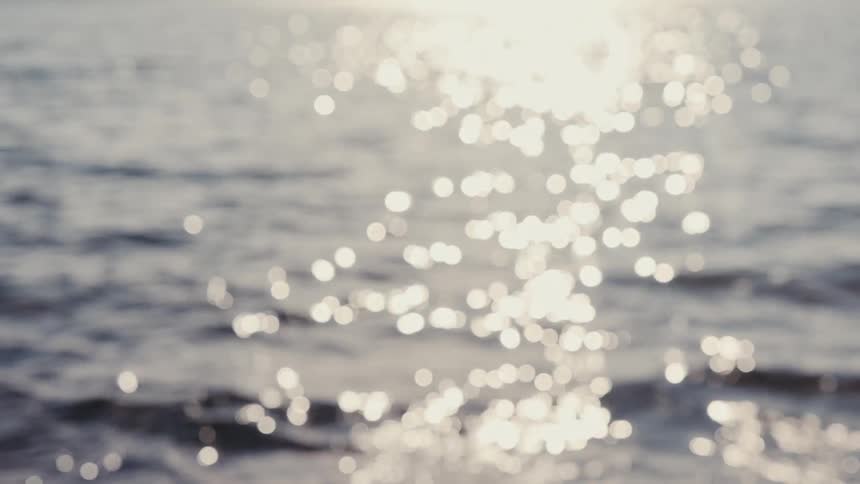Sunlight reflections scatter across the sea surface
