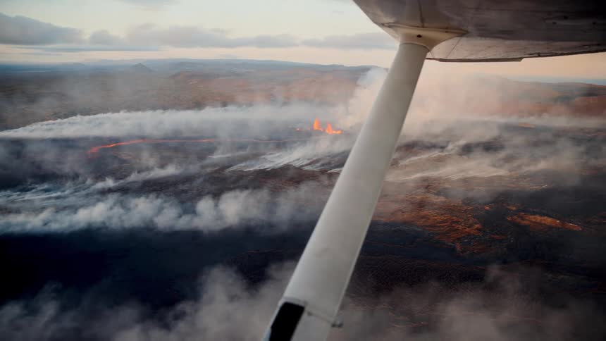Aerial view of active lava flow with smoke seen from a light aircraft