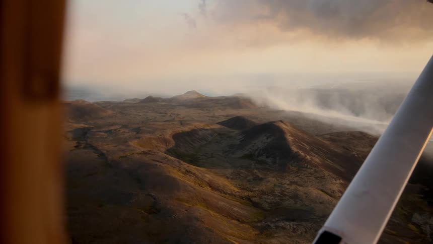 The plane glides over the mountain range