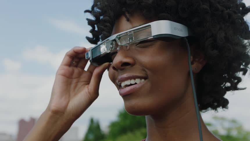 A woman looks through a pair of smart glasses