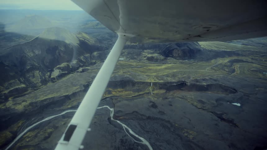 A view of rocks from a plane flying in the air