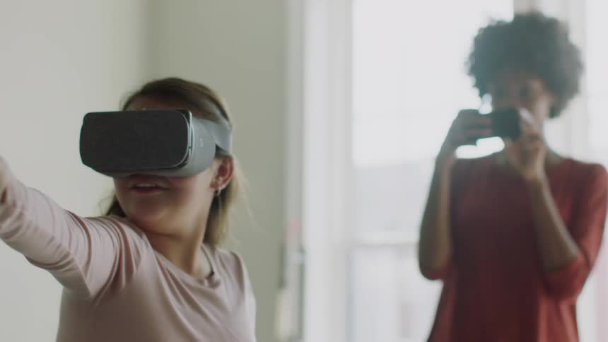 A young girl plays with a vr headset