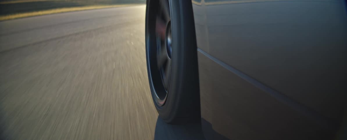 Wheel of a car moving on asphalt