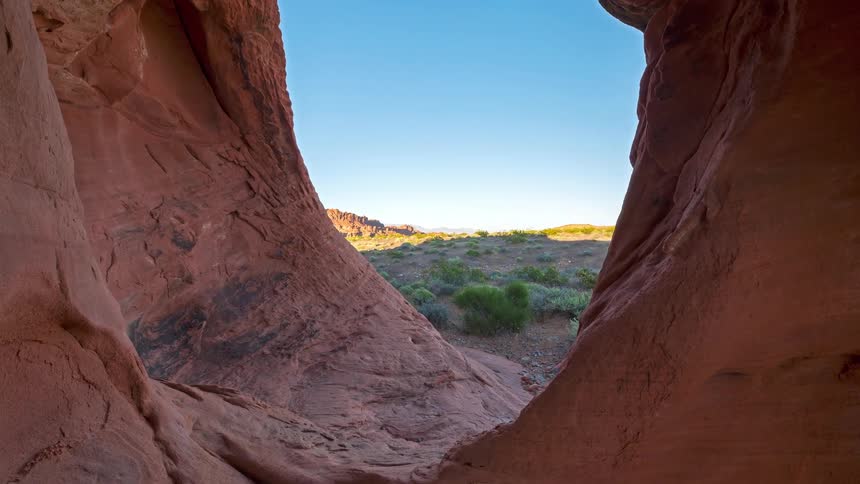 Red rock formation interior overlooking desert terrain