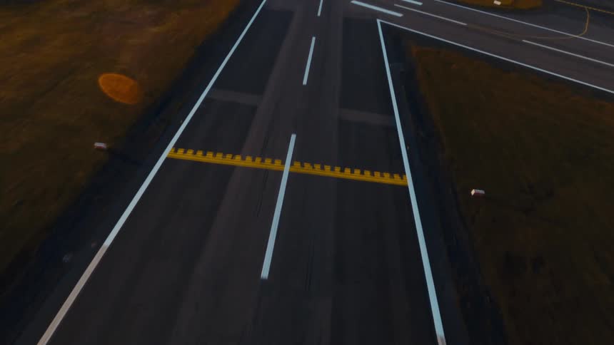 Small airplane rolling down the runway and taking off with houses and buildings in the distance
