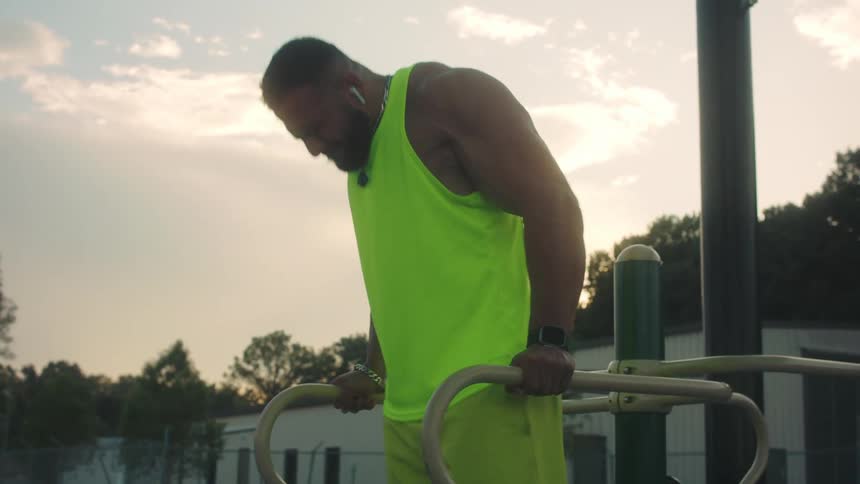 The man is working out in the park