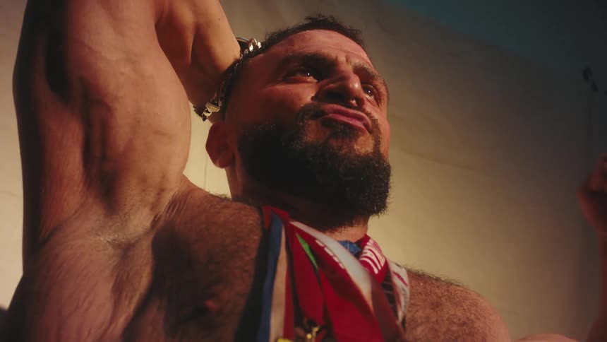 A man flexing at a competition