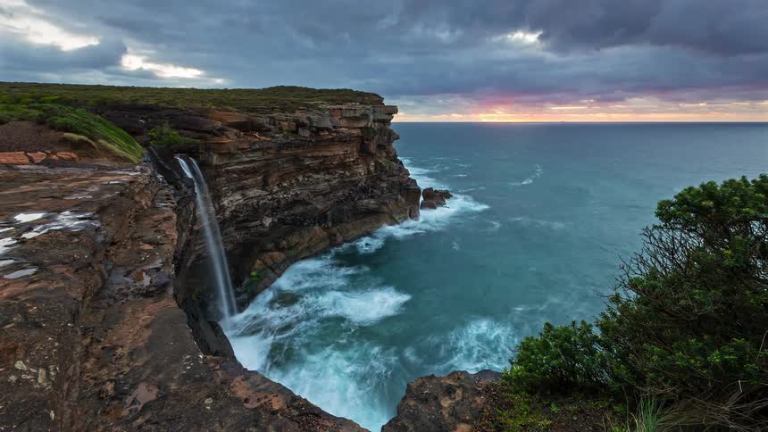 A view of a timelapse of water on cliffs