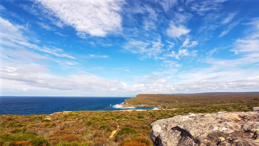 A view of a coast with waves crashing on them