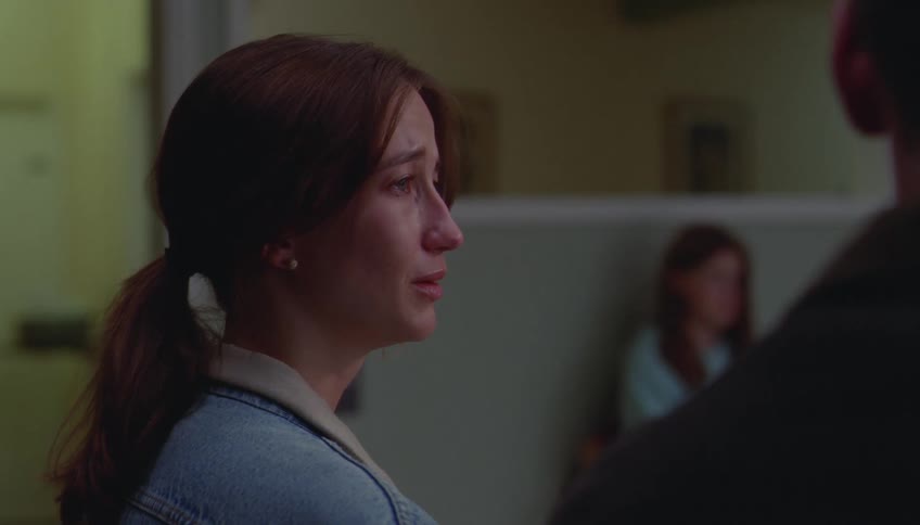 Crying woman talks to the man sitting next to her