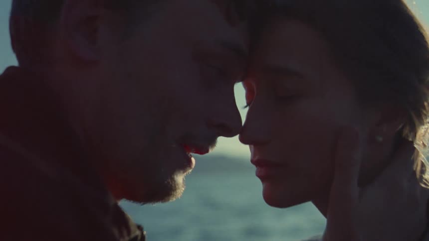 Couple gently sharing emotional support outdoors in soft lighting