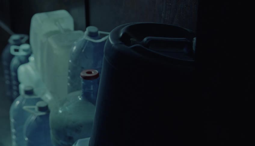A view of some plastic jugs and bottles stacked up