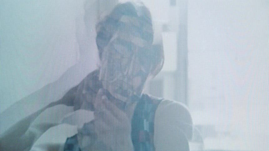 A woman moves her hands around her head in a multiple exposure video