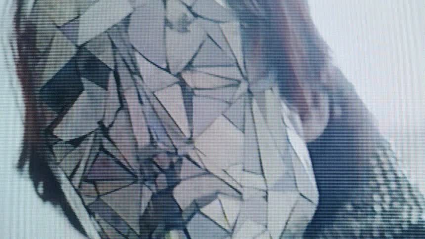The light reflects off the womans mask