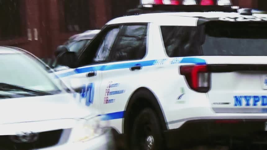 Nypd police suv driving along an urban street in rainy conditions