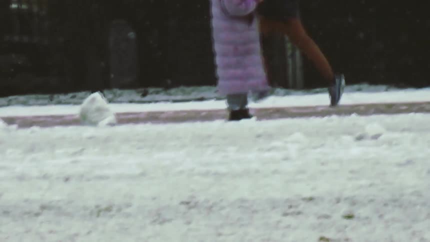 Person running along a snowcovered path in a wooded area