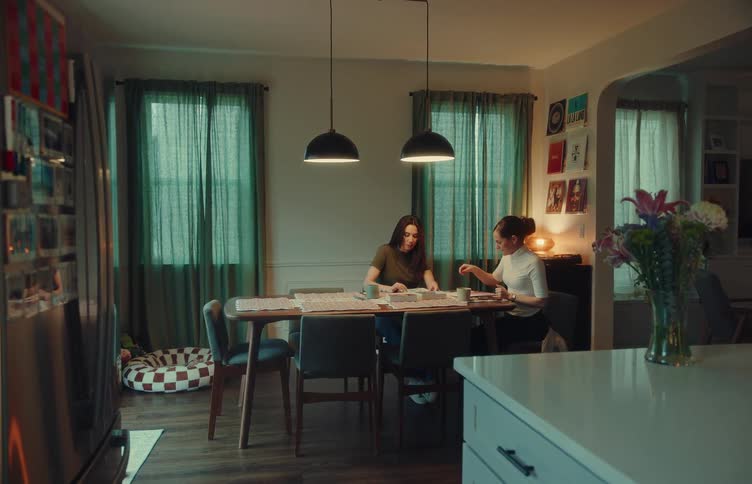 Two people sitting at a table and talking