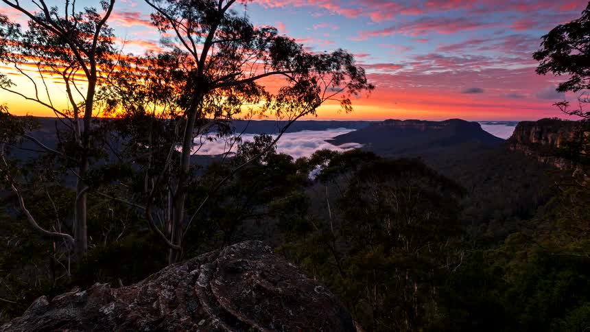 A time lapse of the sun rising over some mountains