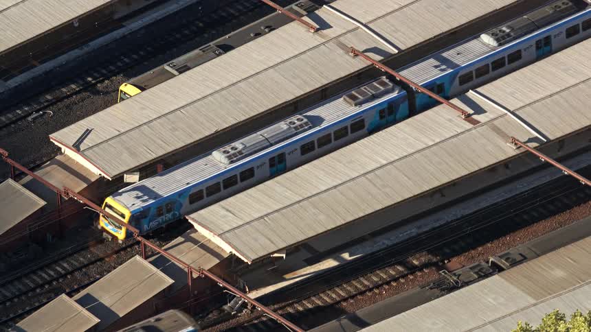 A time lapse of a train station where several passenger trains arrive