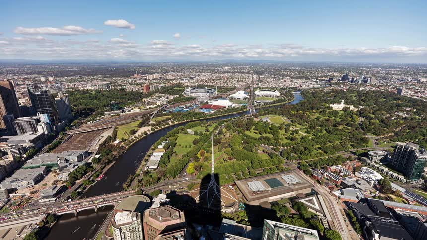 An aerial time lapse of a city with a park in the middle of it
