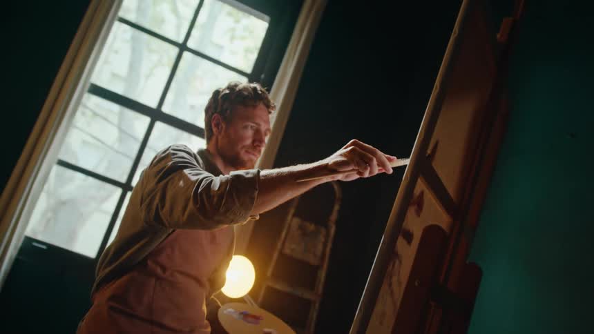 A man painting on a canvas