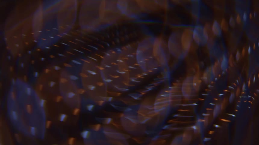 Abstract patterns of light and shadow create a blurred visual effect with warm and cool tones