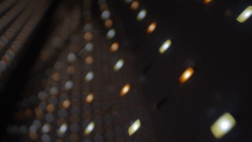 Blurred points of light form an abstract pattern on a dark background