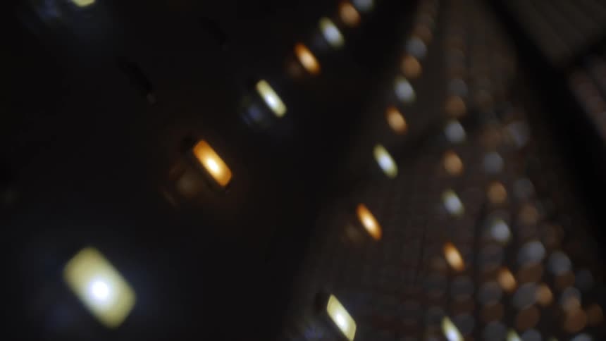 Outoffocus light points in warm and cool tones aligned in diagonal rows against a dark background