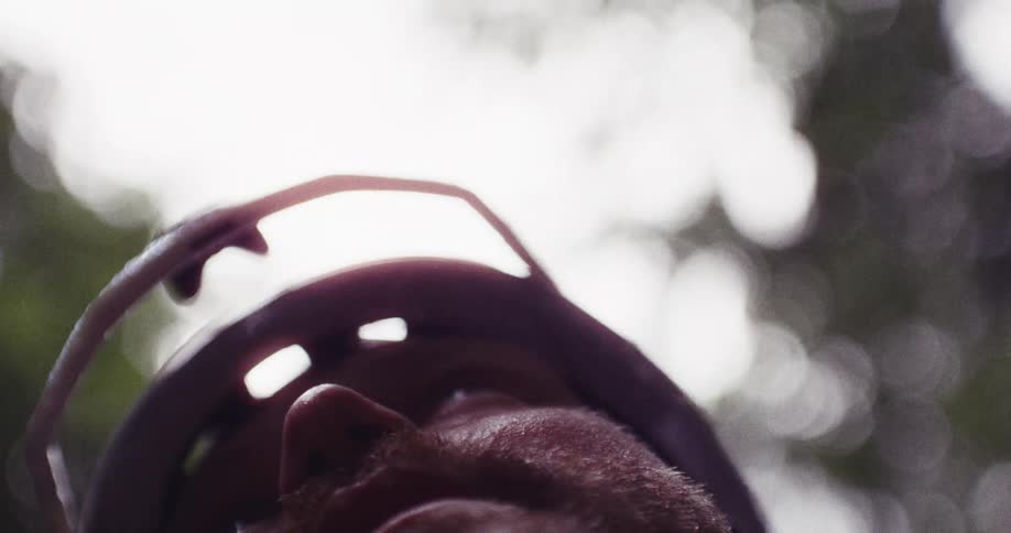 The man looks up at the cloudy sky