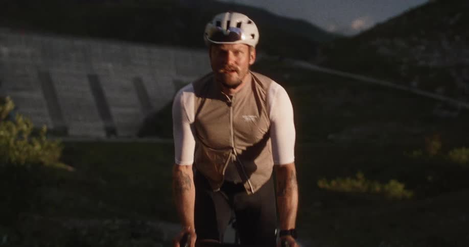 A man riding a bicycle up a mountain road