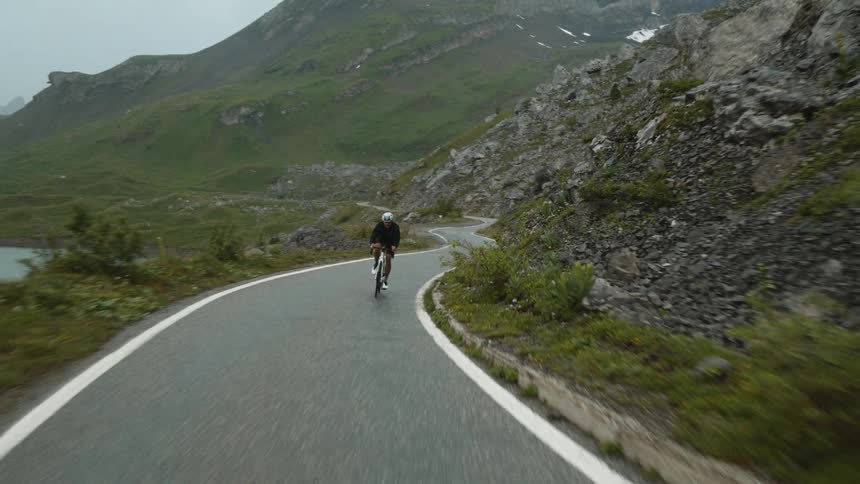 A cyclist riding down a street