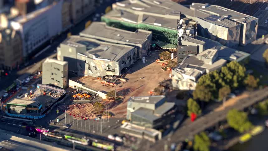 A sprawling urban construction site surrounded by large buildings with cranes equipment and active work areas clearly visible