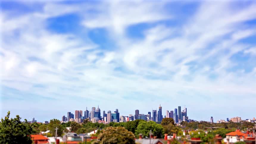 Clouds drift over the skyline of a city