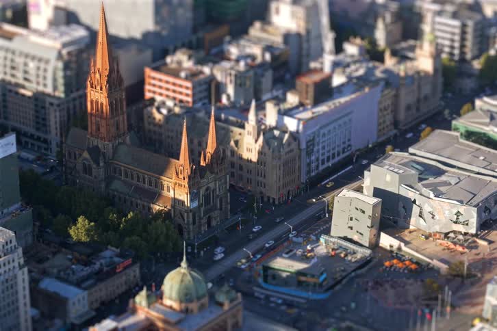 Historic cathedral with pointed towers amid urban blocks and trafficlined streets