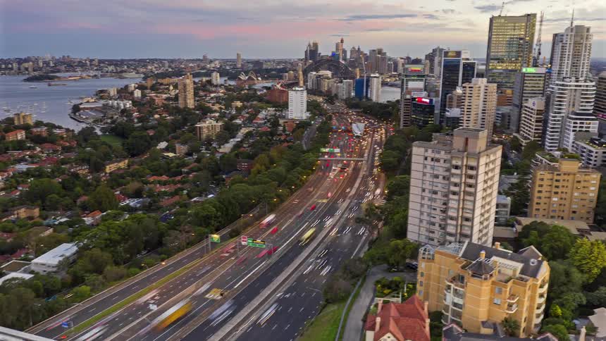 A time lapse of vehicles on the edge of a city