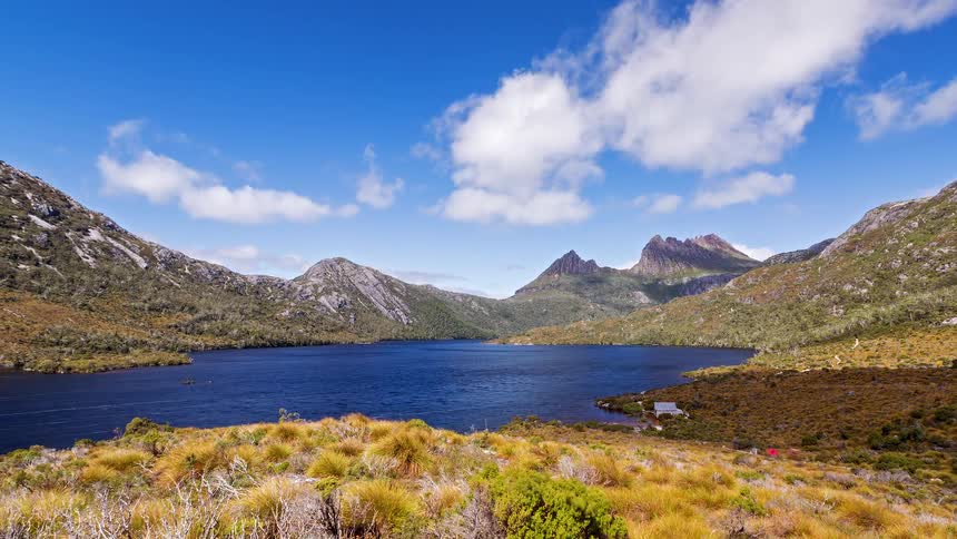 A view of a lake at the base of a mountain