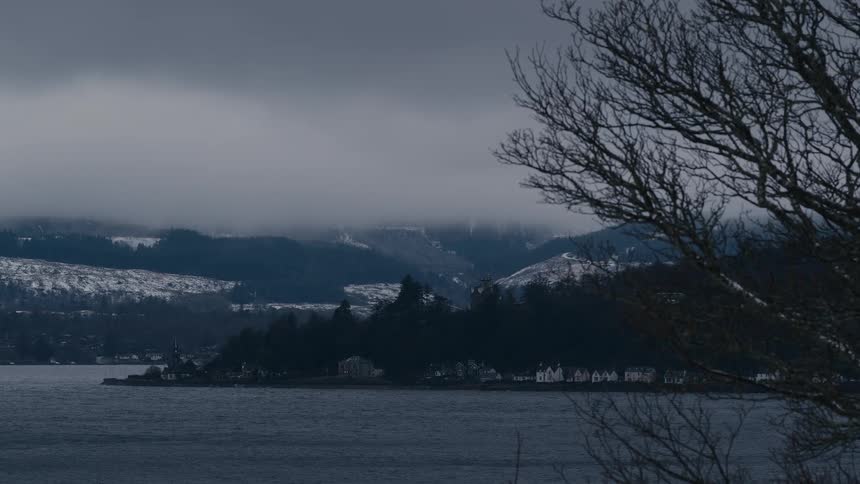 A lake at the base of snow covered mountains