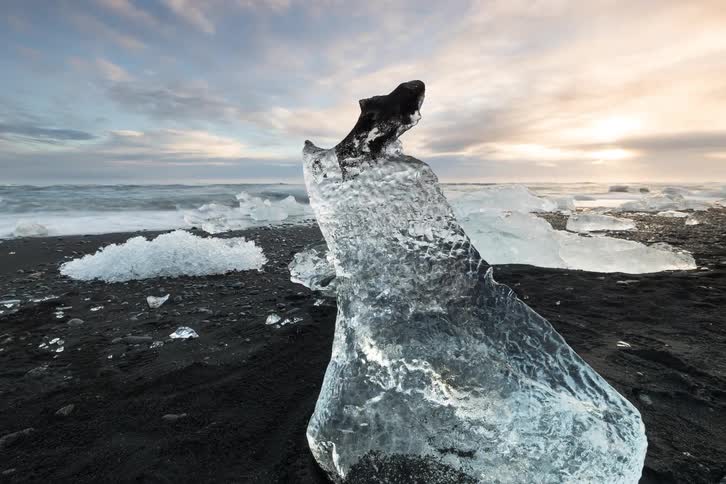 Melting ice along the coast as waves roll into shore