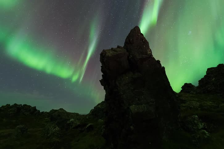 The aurora above some rocks outdoors at night