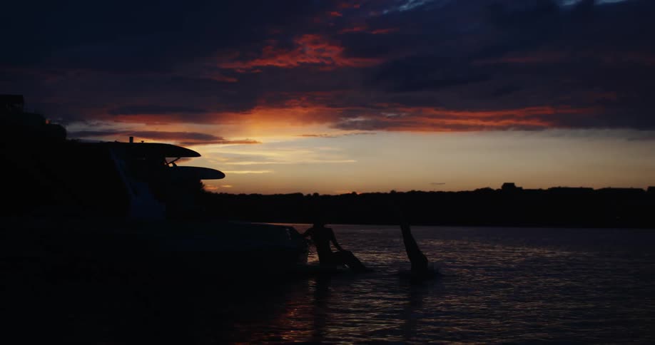 A woman diving off a boat into water