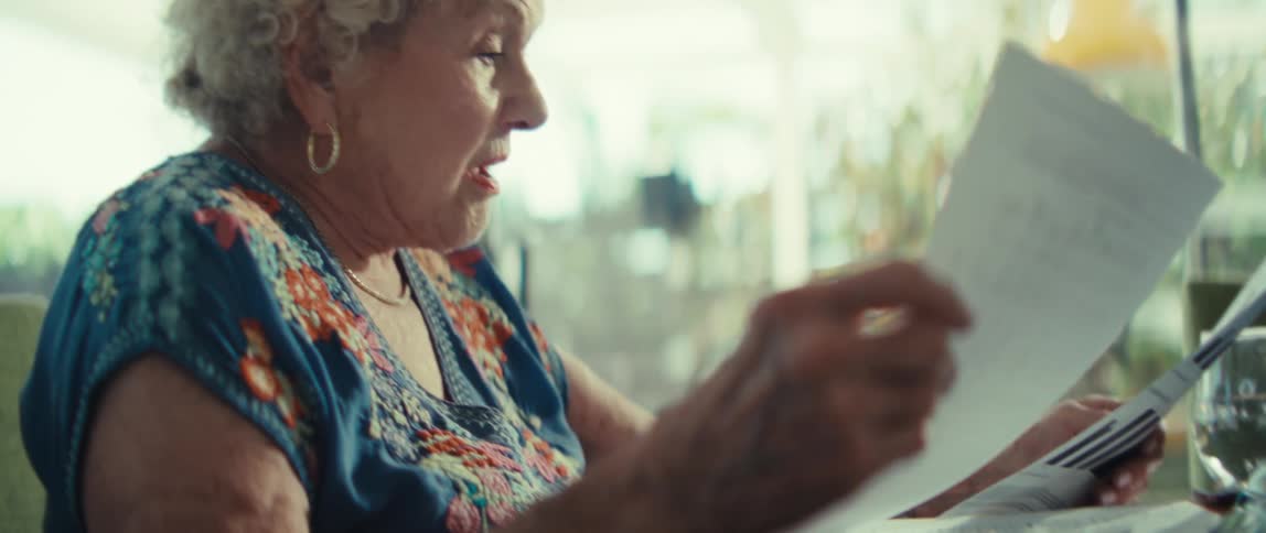 A woman sitting in a room looking over papers