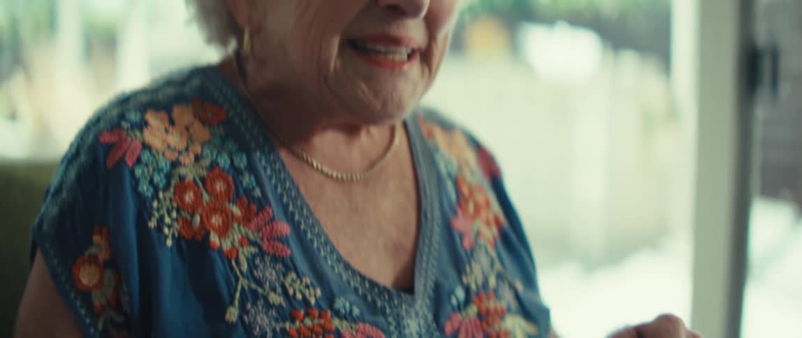 Woman smiles while referencing multiple charts during a video call
