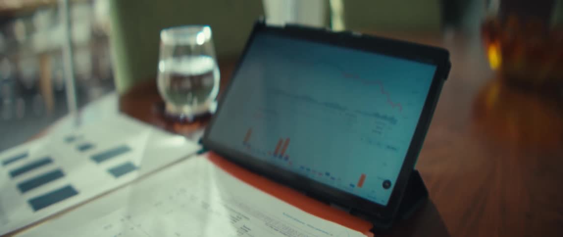 A person using a laptop with graphs
