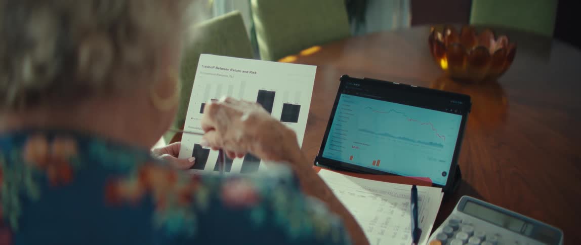 A woman using a laptop and paper in a room