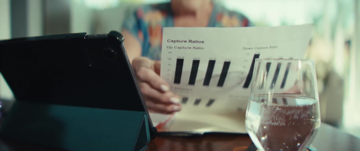 An elderly woman reviews a document and uses her tablet computer