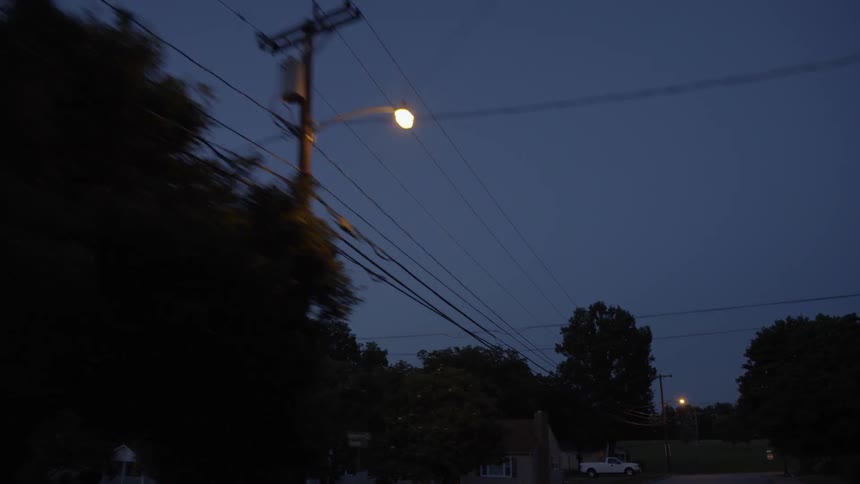 The power lines are across the dawn sky