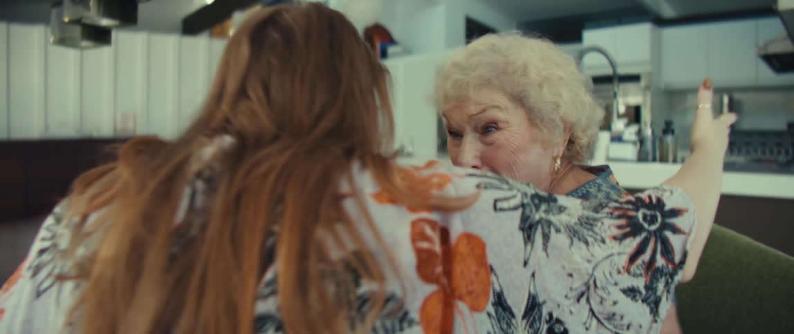 Two women talking and hugging